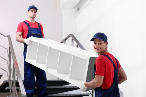 Moving team handling large furniture removals in Harringay apartment building