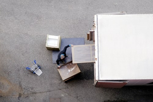 Loading furniture into a moving truck in Harringay street