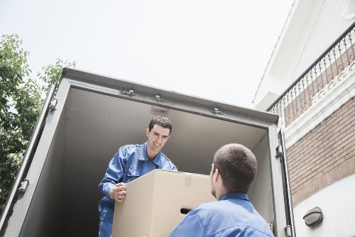 Removal team carrying furniture through a Harringay flat